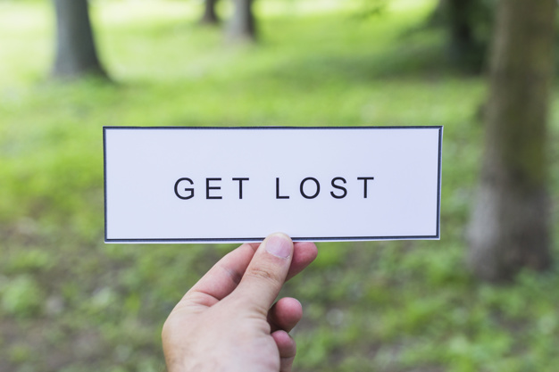 hand-holding-get-lost-label-outdoors_23-2147842499