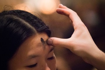 A woman receives ashes at  Saint Patrick's Cathedral on Ash Wednesday in New York
